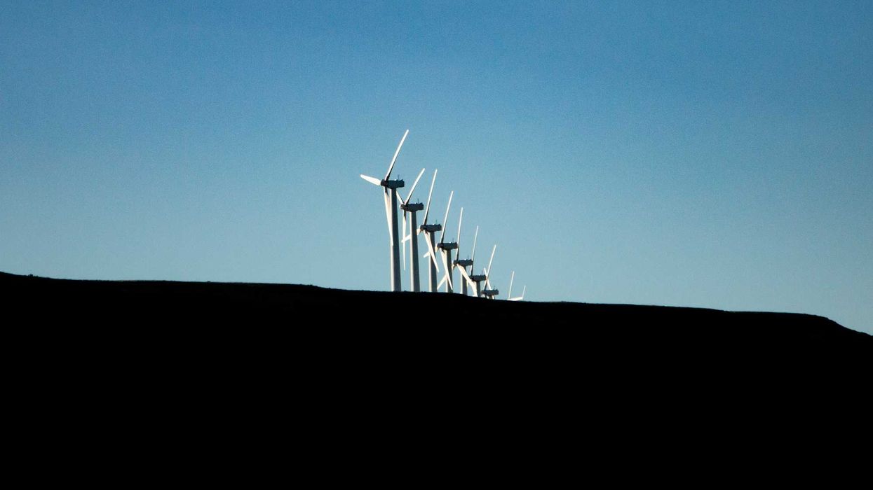 wind turbines under blue sky during daytime