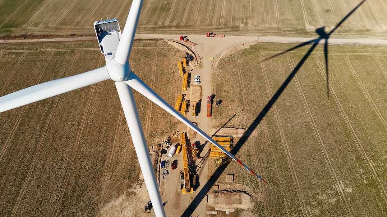 Windmill turbine maintenance at a construction site with cranes for assembling windmill tower,