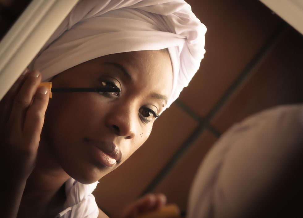 woman applying makeup mascara.