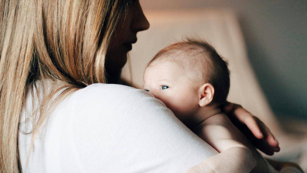 Woman carrying a newborn