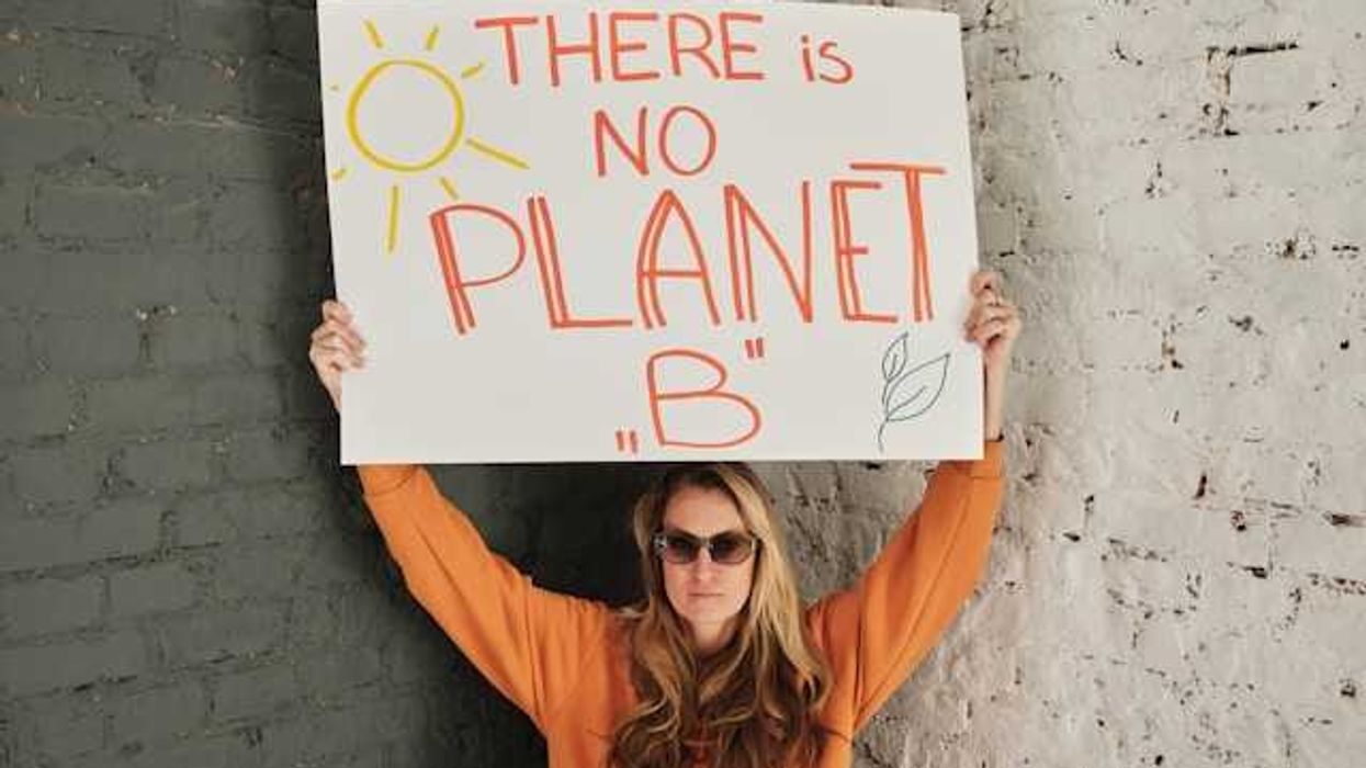 Woman holding sign that says There is no Planet B