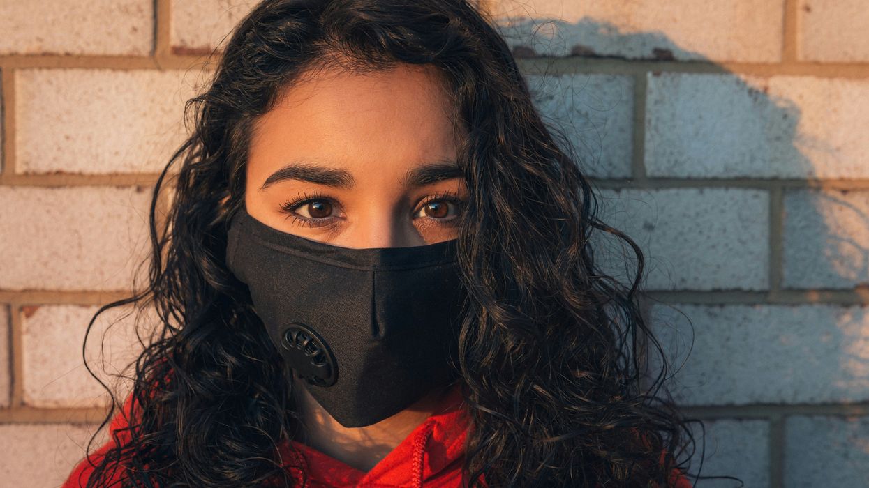woman in red shirt wearing black mask