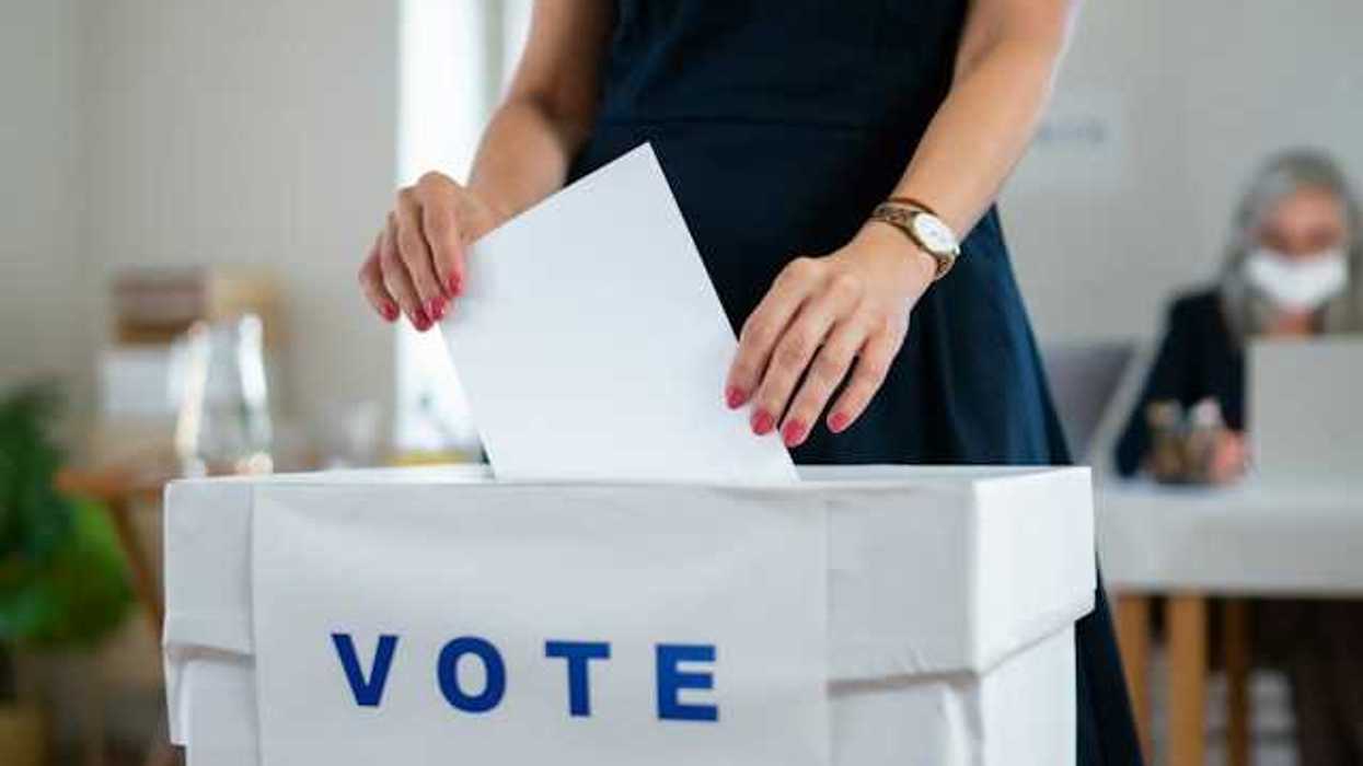 Woman putting her ballot in a voting box