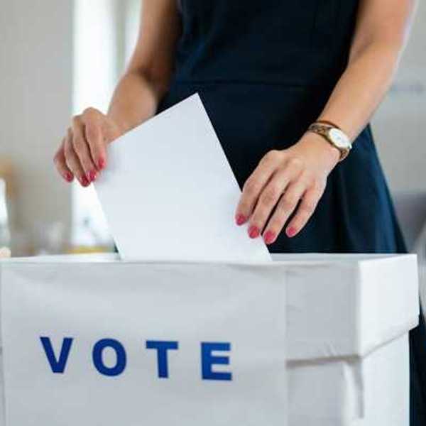 Woman putting her ballot in a voting box