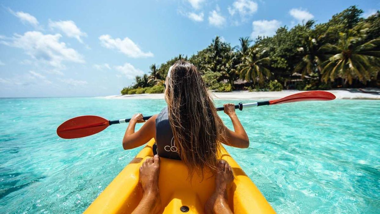Woman sea-kayaking in the Maldives