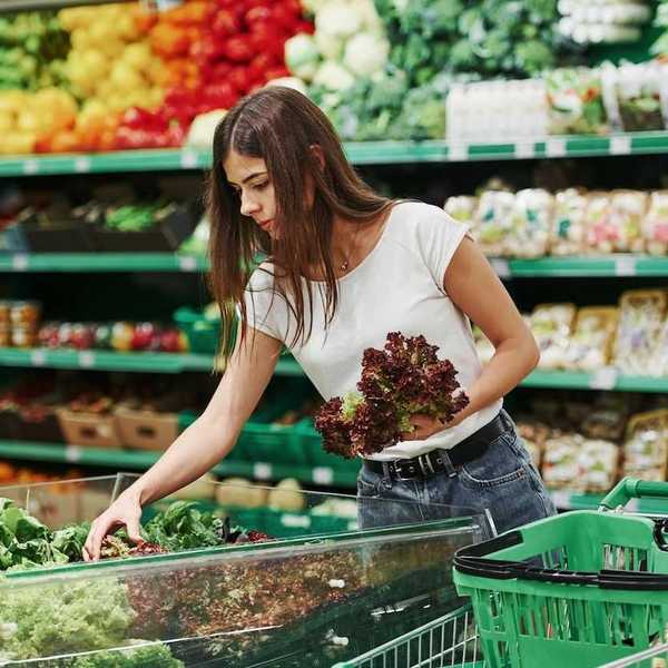 Woman shopping for fresh produce in a supermarket