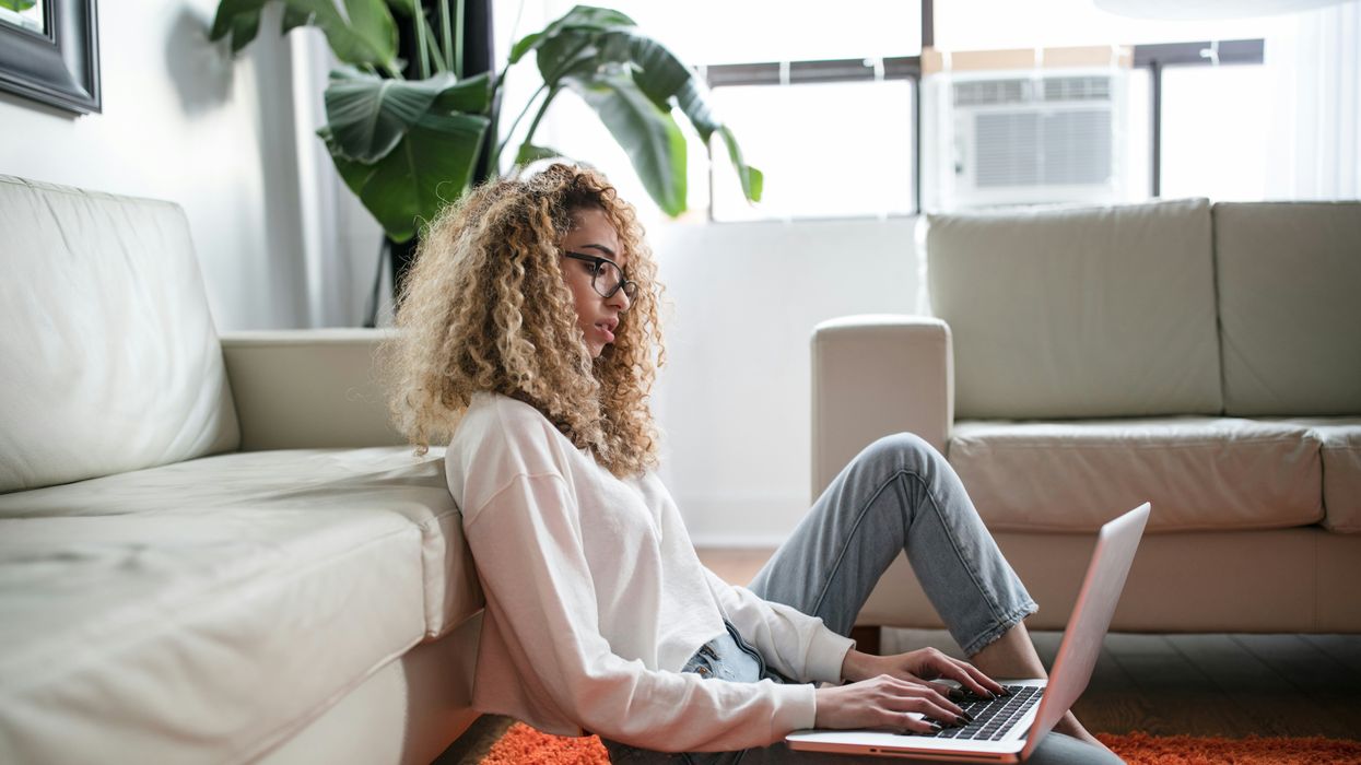 woman sitting on floor laptop