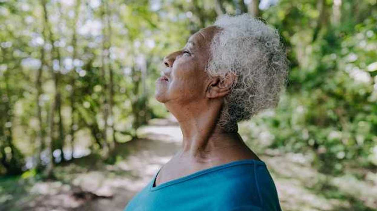 Woman stopping to breathe on a trail path