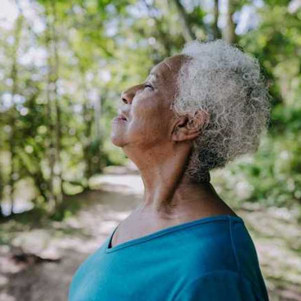 Woman stopping to breathe on a trail path