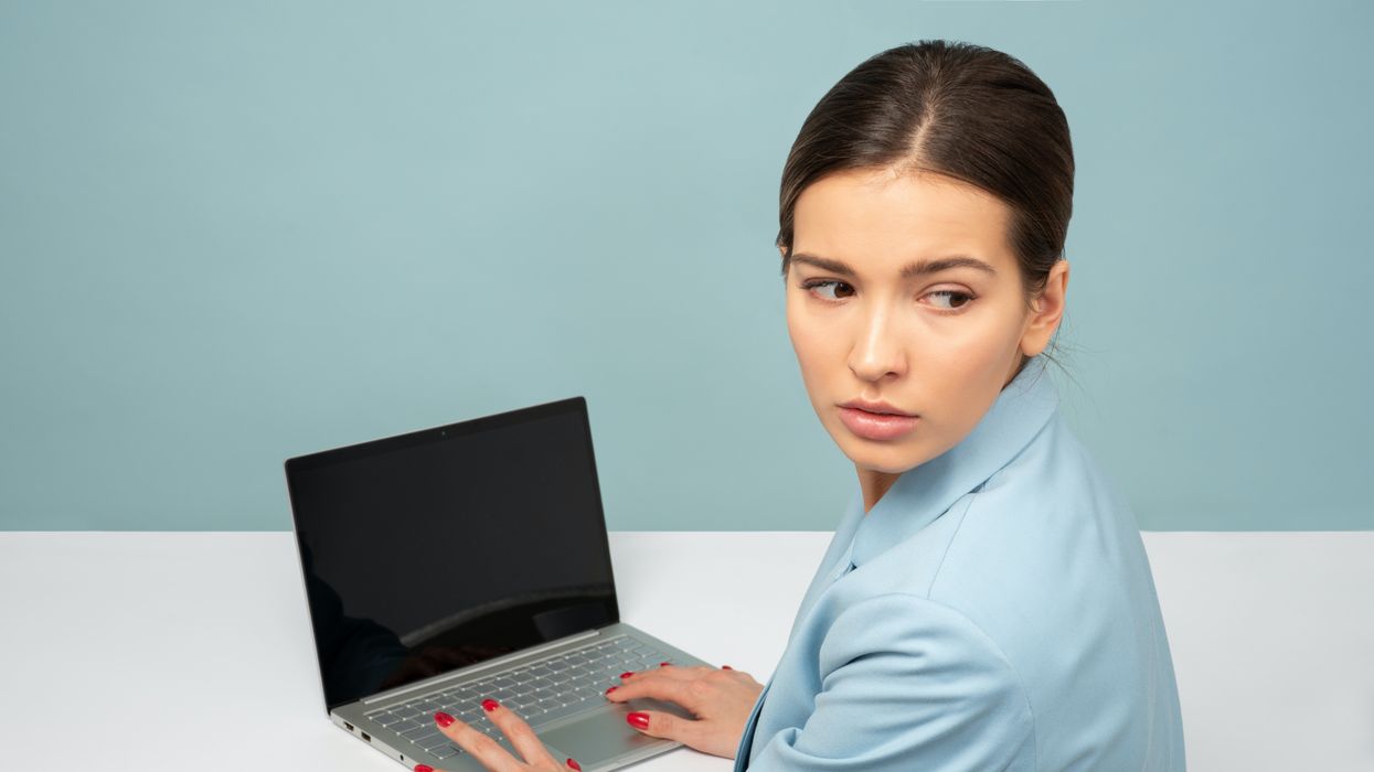 woman typing laptop worried