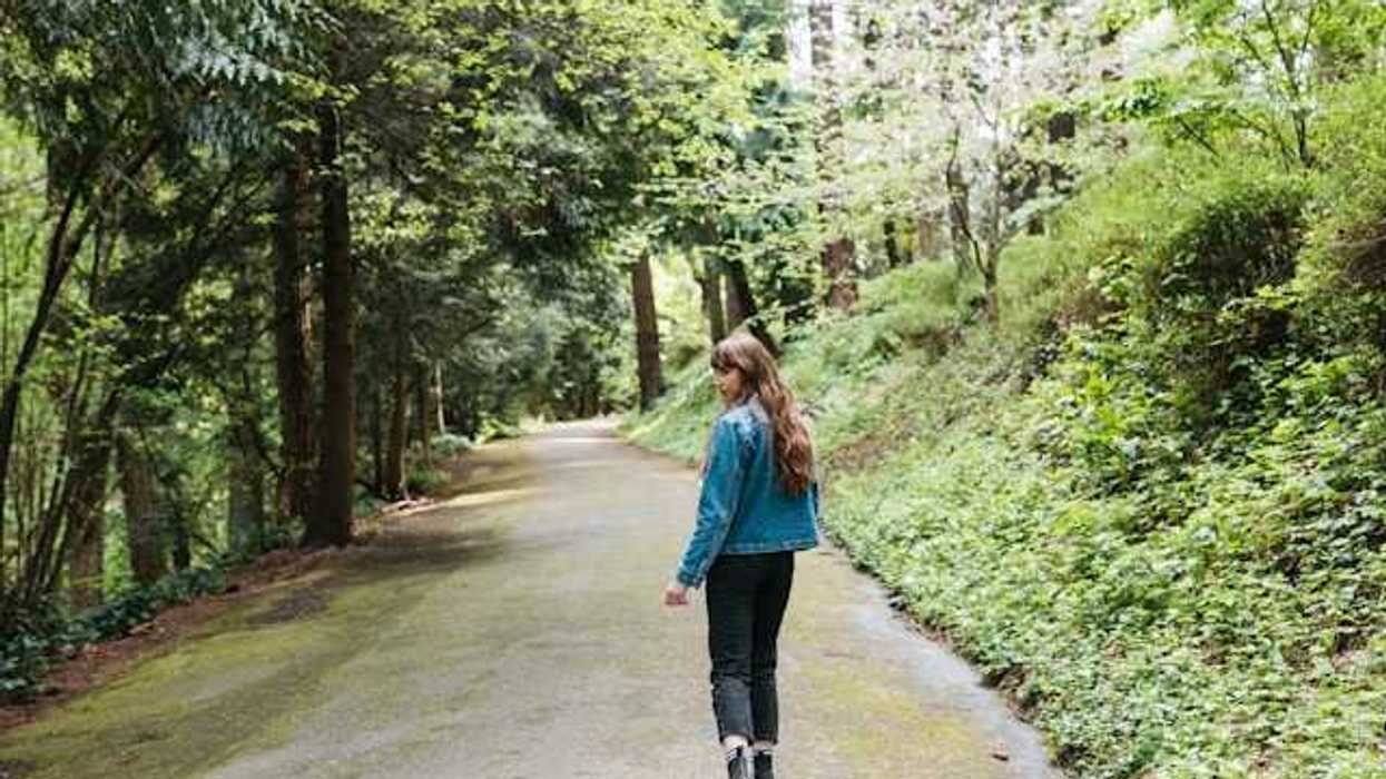 Woman walking on a forest path