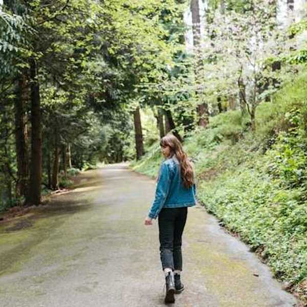 Woman walking on a forest path