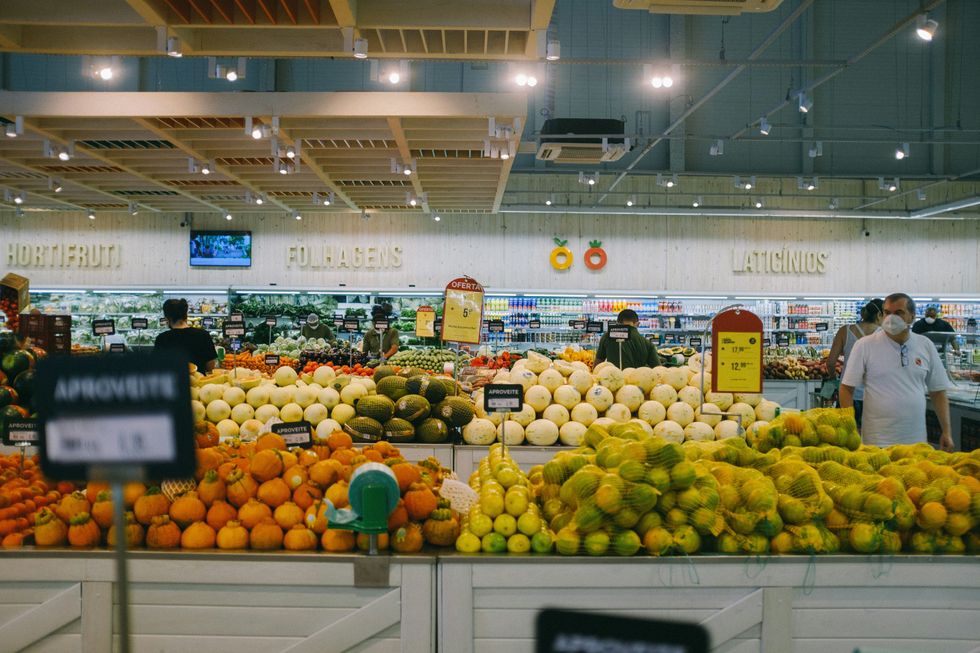yellow and green fruits on white displays in a supermarket.