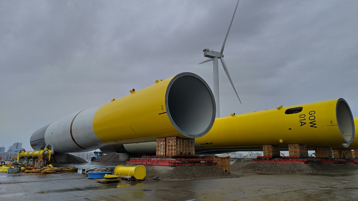 Yellow and white wind turbine towers waiting to be installed