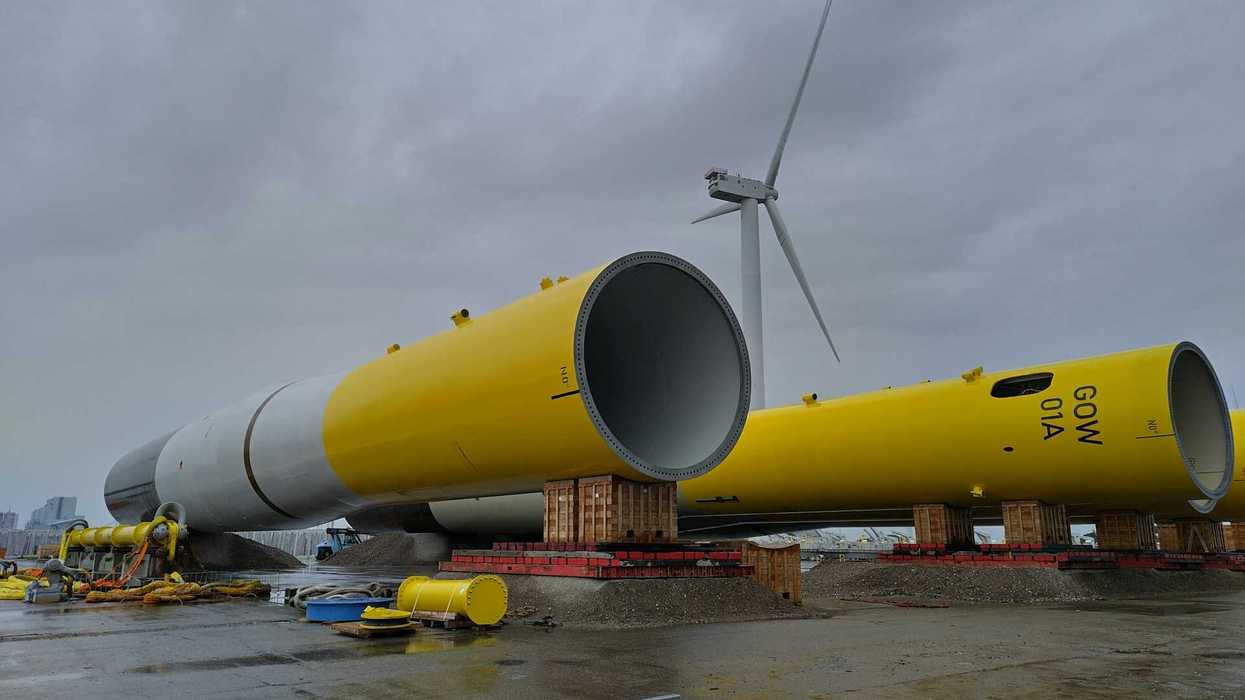 Yellow and white wind turbines awaiting assembly and deployment