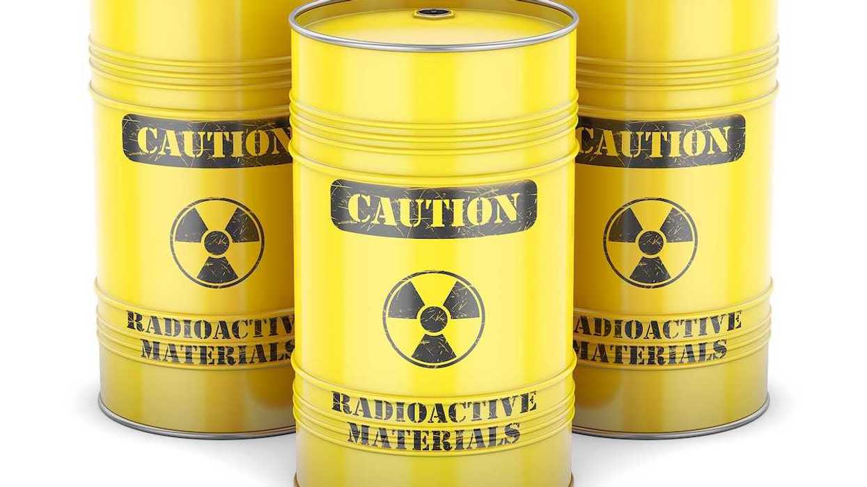 Yellow barrels labeled "CAUTION Radioactive Materials" in black letters