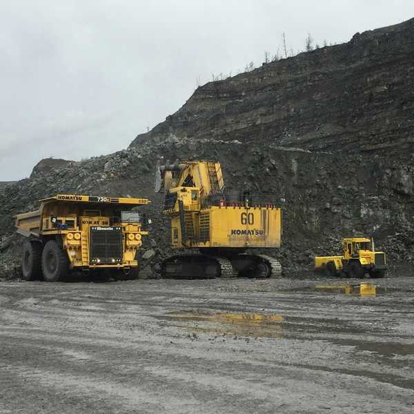Yellow mining equipment parked in a coal mining cut