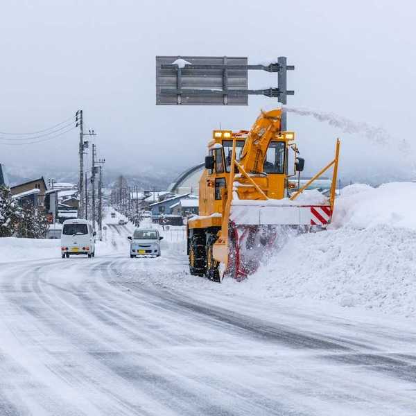 Yellow snow removal equipment clearing winter streets