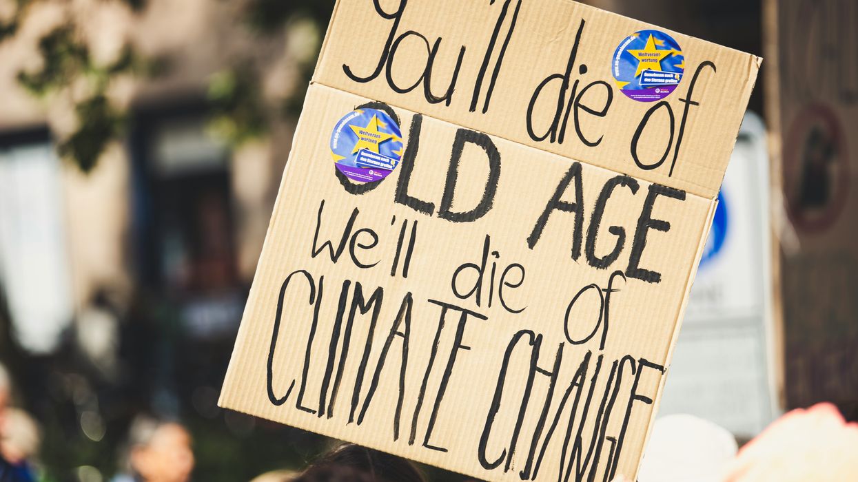 you'll die of old age we'll die of climate change text on protest sign.