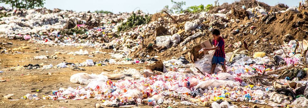 young boy searches plastic waste