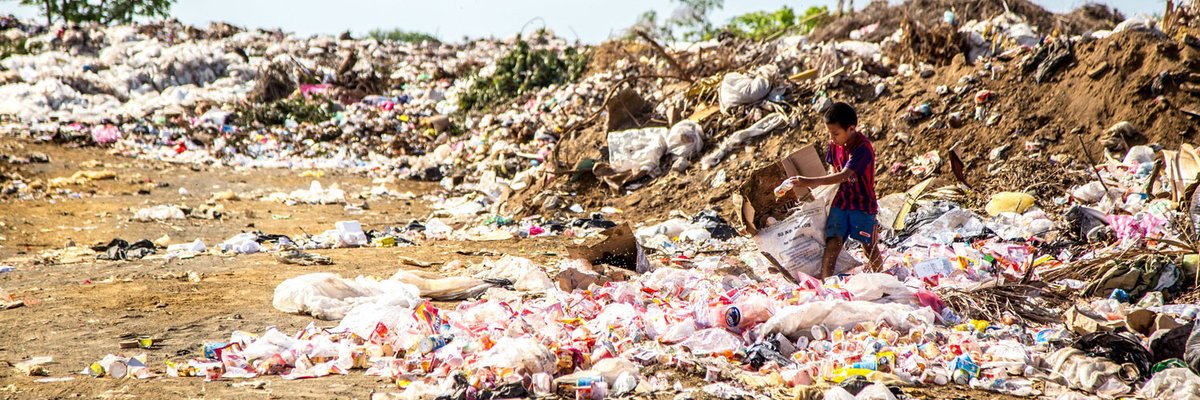 young boy searches plastic waste