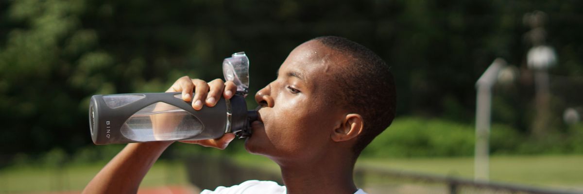 young man drinking water from bottle