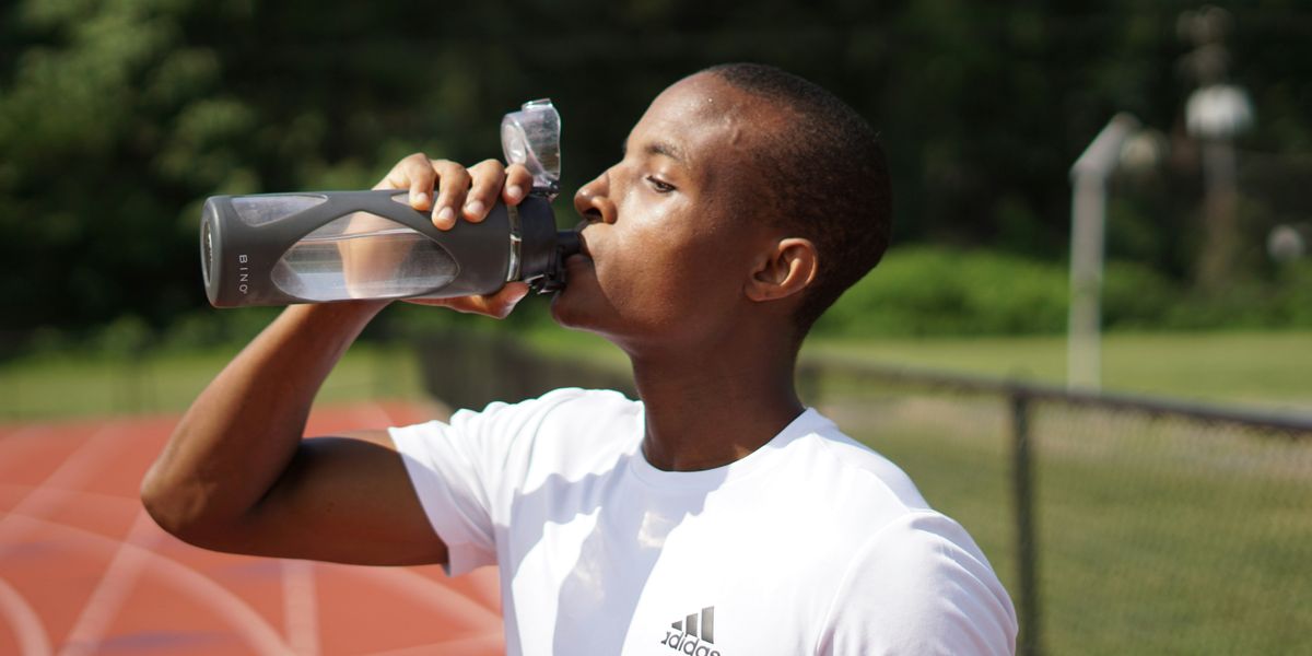 young man drinking water from bottle