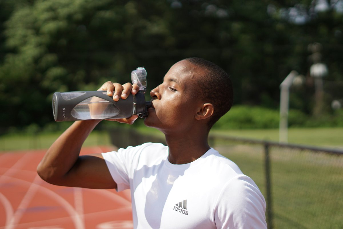 young man drinking water from bottle