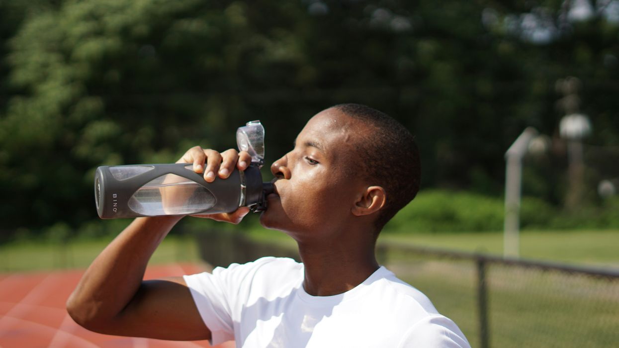 young man drinking water from bottle