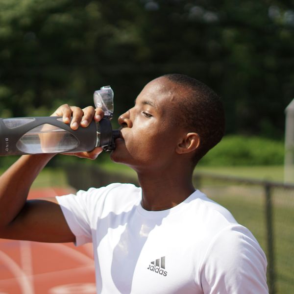 young man drinking water from bottle
